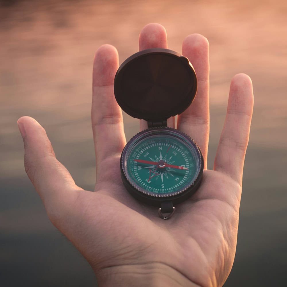 Hand Holding Compass