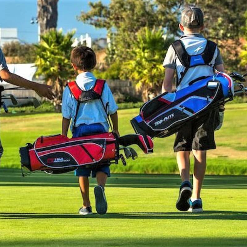Boys walking with golf bags