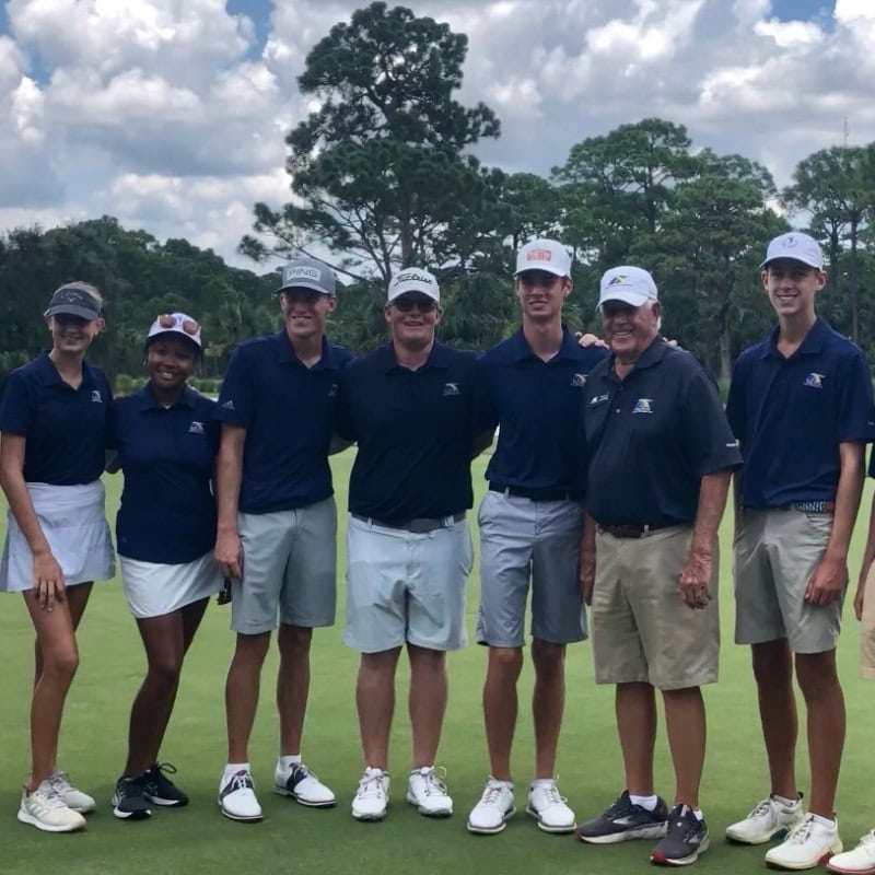 Golfers al wearing blue shirts