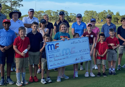 Group holding donation check