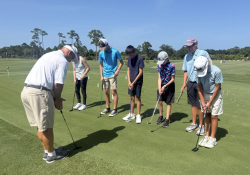 Man teaching boys to put