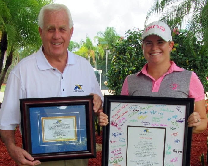 Two people holding framed documents