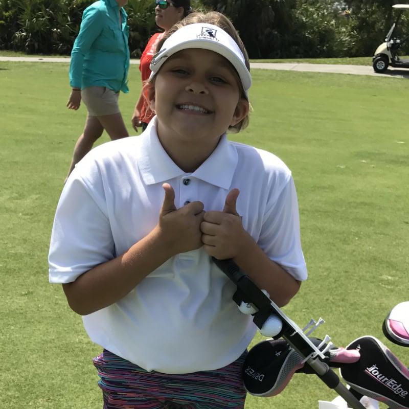 Happy young female golfer