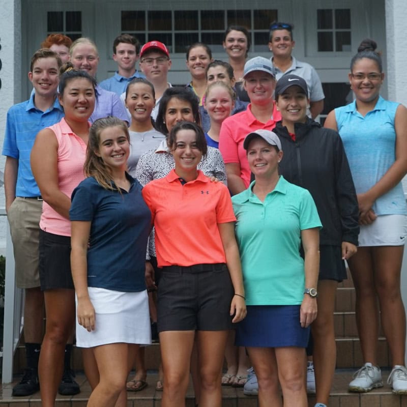 Young golfers on clubhouse steps